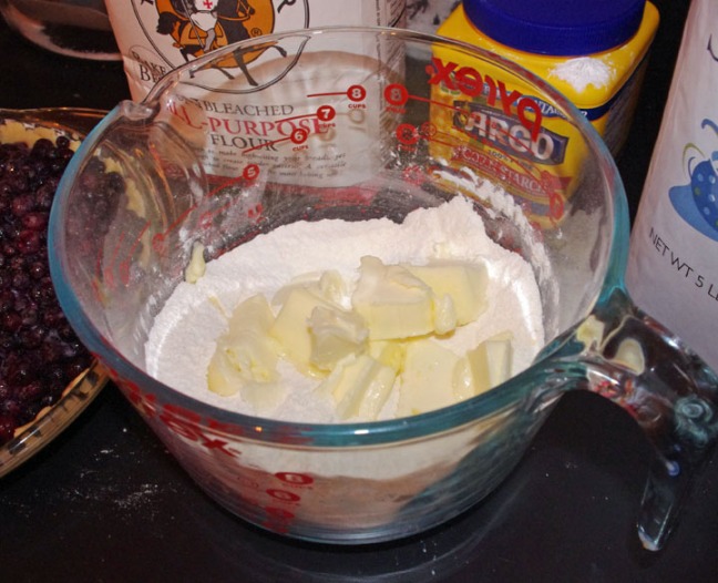 To start, blend the flour and sugar together in a bowl.  Cut up slightly softened salted butter into the mixture and then blend, using a pastry blender, until crumbly.