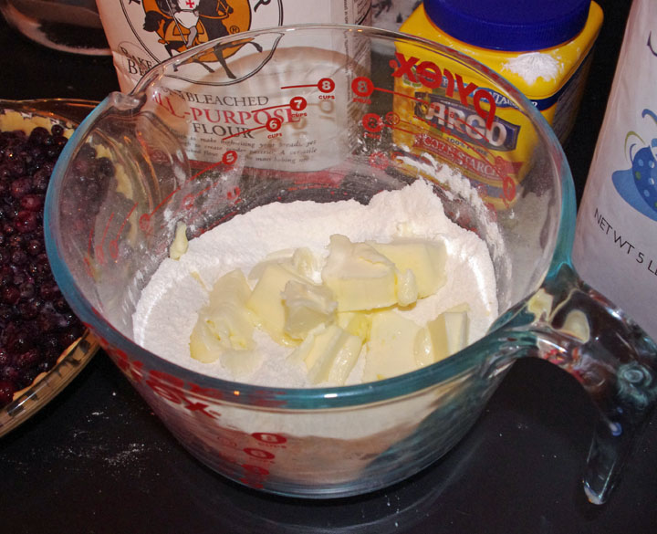 To start, blend the flour and sugar together in a bowl. Cut up slightly softened salted butter into the mixture and then blend, using a pastry blender.